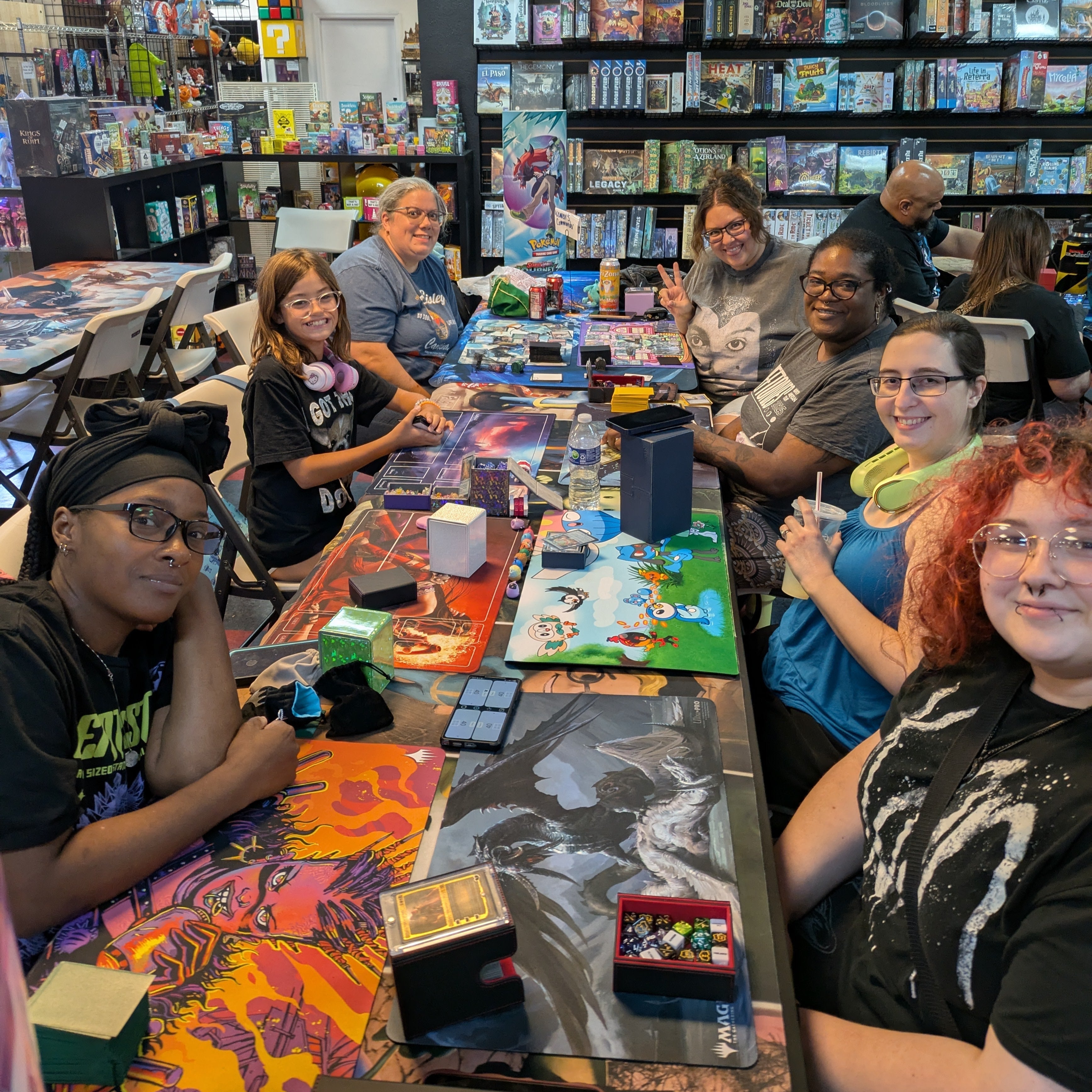 Players gathered around a table at J and J Gaming Factory