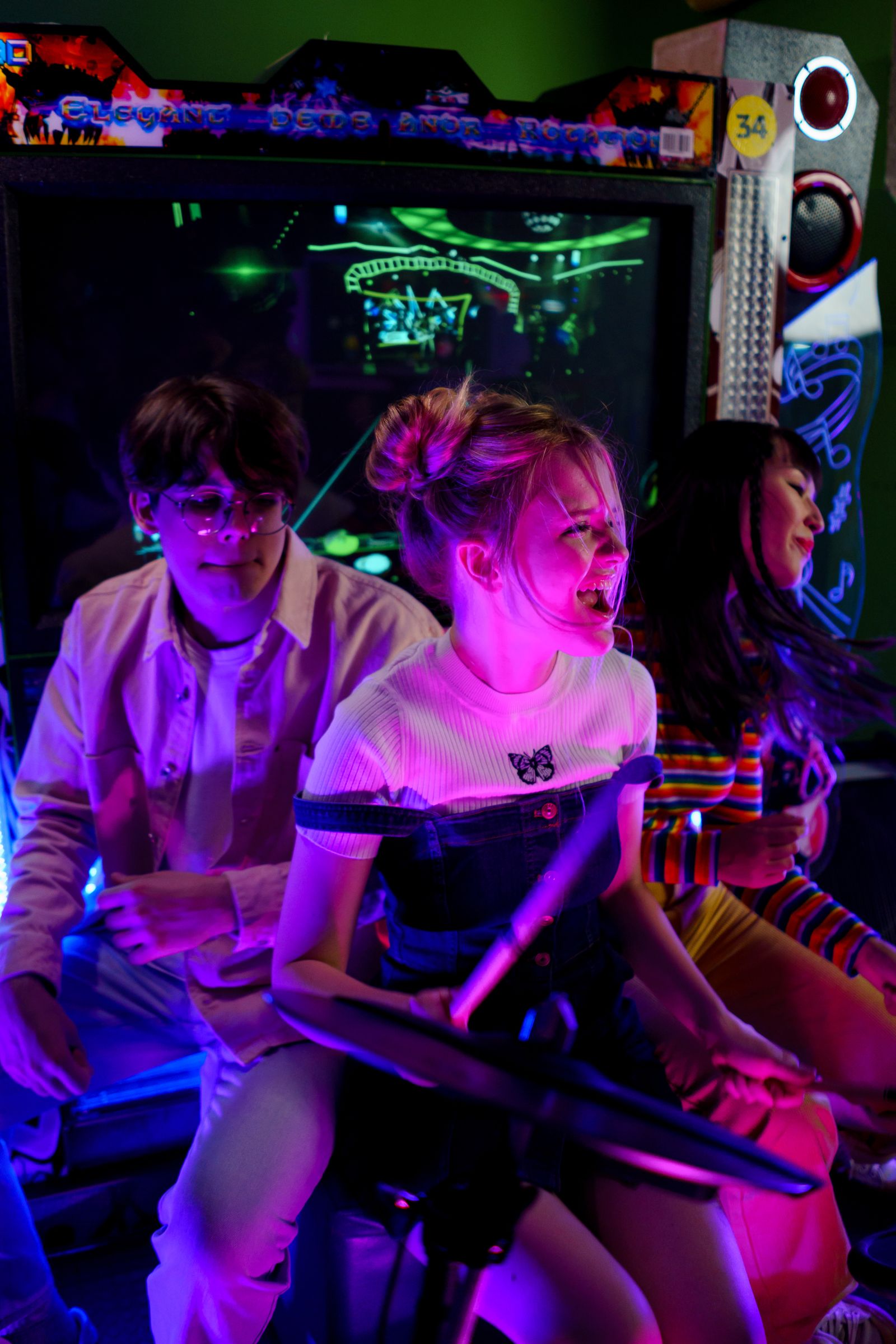 Friends enjoying a colorful neon arcade